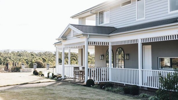 A two-story house with a covered porch and a well-maintained lawn. - 'Saddle Ridge' - Kangaroo Valley Private Estate (Kangaroo Valley)
