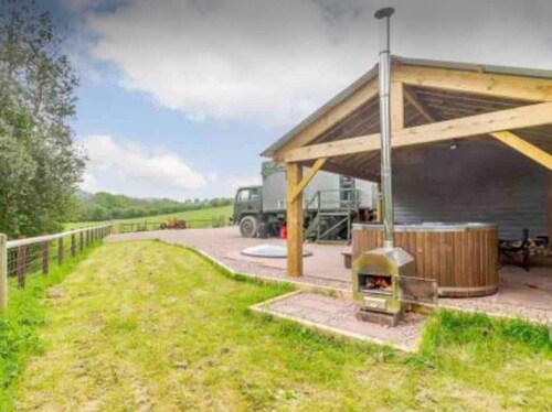 Unique stay in your very own army truck. Sleeps 4. Hot tub. Tranquil setting.