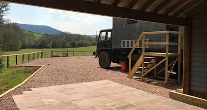 Unique stay in your very own army truck. Sleeps 4. Hot tub. Tranquil setting.