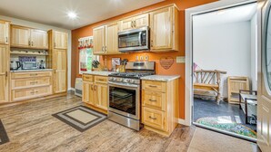 A modern kitchen with wooden cabinets, stainless steel appliances, and a large oven. - Wilmington Retreat Near Trails, Skiing & Festivals (Wilmington)