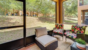 A sunlit patio with wicker furniture and a view of a courtyard. - Davenport Retreat w/ Resort Perks, 9 Mi to Disney! (Davenport)