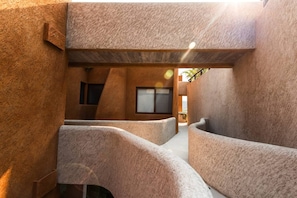A modern interior with curved seating areas and a large window.