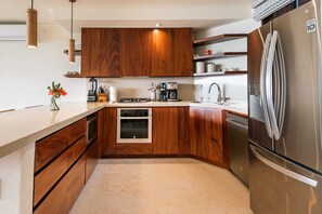 Enjoy cooking and preparing beverages in this kitchen with an oven and coffee station.