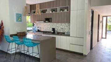 Fridge, microwave, coffee/tea maker, cookware/dishes/utensils