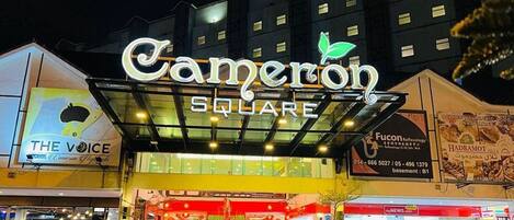 A hotel entrance with a prominent sign reading "Cameron Square".