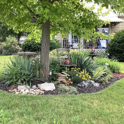 Large private fenced yard with guest patio, fire pit and surrounding gardens.