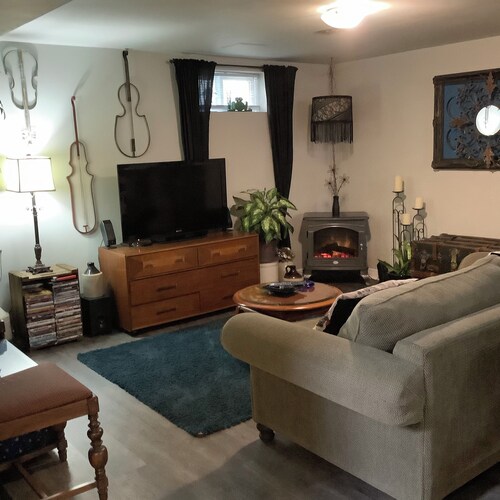 Large private fenced yard with guest patio, fire pit and surrounding gardens.