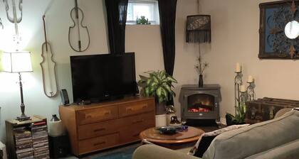 Large private fenced yard with guest patio, fire pit and surrounding gardens.