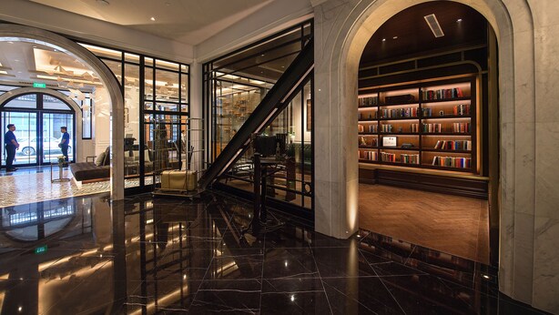 A lobby with a marble floor, a staircase, and a bookshelf area. - Yangon Excelsior Hotel (Yangon)