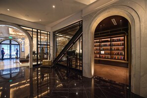 A lobby with a marble floor, a staircase, and a bookshelf area. - Yangon Excelsior Hotel (Yangon)