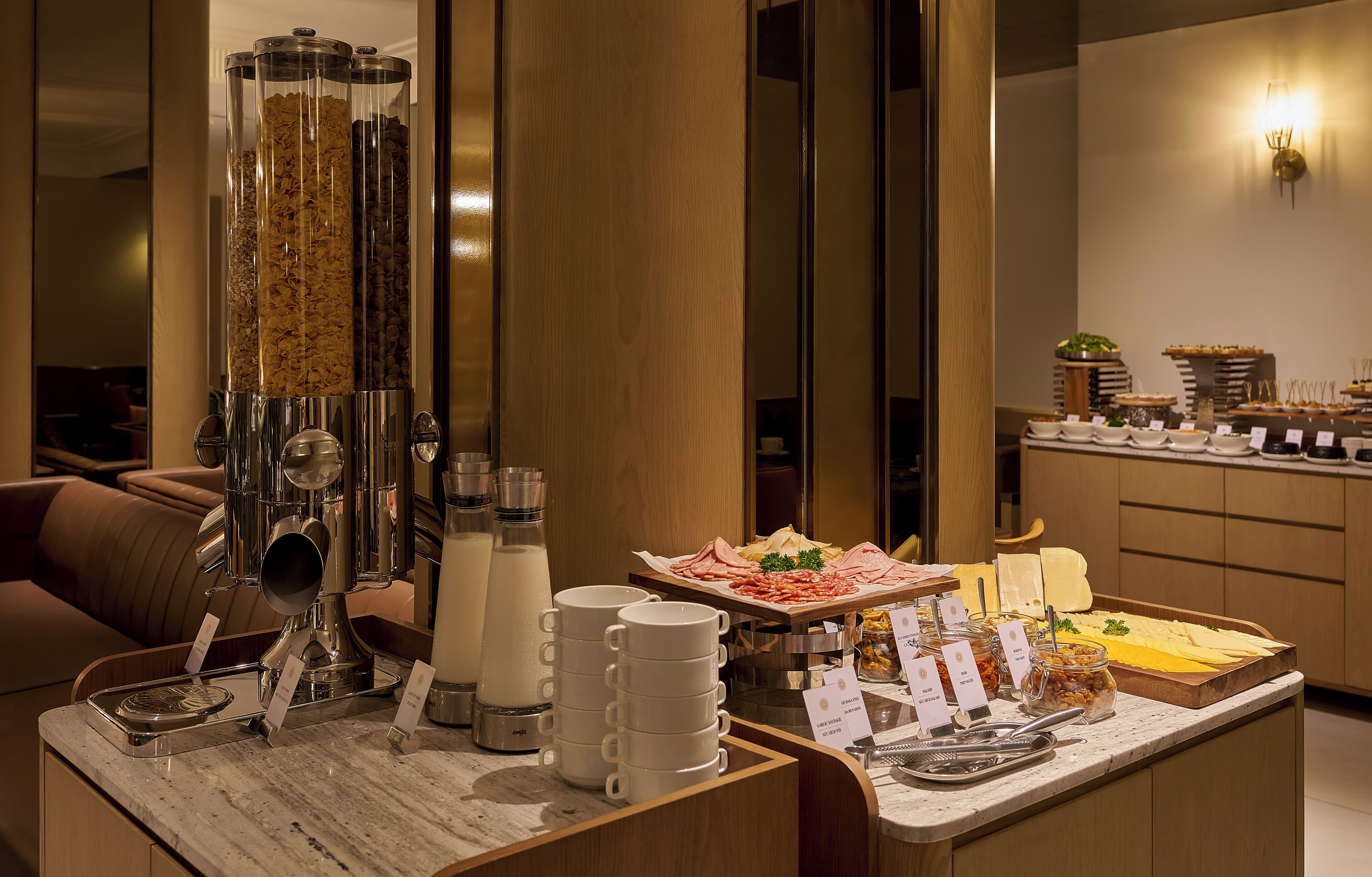 A breakfast buffet with various food items and a coffee machine.