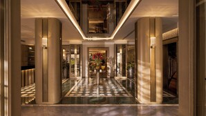 A modern hotel lobby with a checkered floor, tall columns, and a central chandelier. - La Siesta Premium Saigon Central (Ho Chi Minh City)