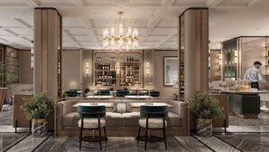 A modern hotel lobby with a central seating area, a bar, and a wine display. - La Siesta Premium Saigon Central (Ho Chi Minh City)