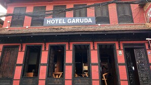 A building with a sign for "The Garuda Bar" and "Hotel Garuda". - Hotel Garuda Bhaktapur (Bhaktapur)