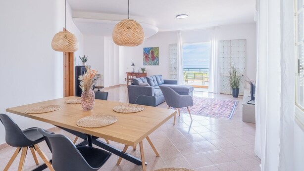 A spacious living area with a dining table, chairs, and a sofa. There is a balcony with a view of the sea. - Detached villa with pool for exclusive use privacy and sea view (Alcamo)