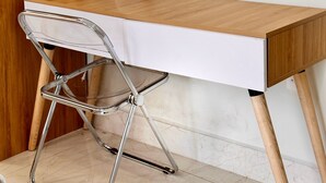 A wooden desk with a white chair, a lamp, and a small wooden hand model. - LalaHouse Spring Apartment (Ho Chi Minh City)