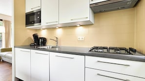 Fridge, stovetop, dishwasher, coffee/tea maker