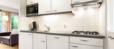 Fridge, stovetop, dishwasher, coffee/tea maker