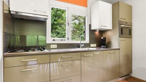 Fridge, stovetop, dishwasher, coffee/tea maker