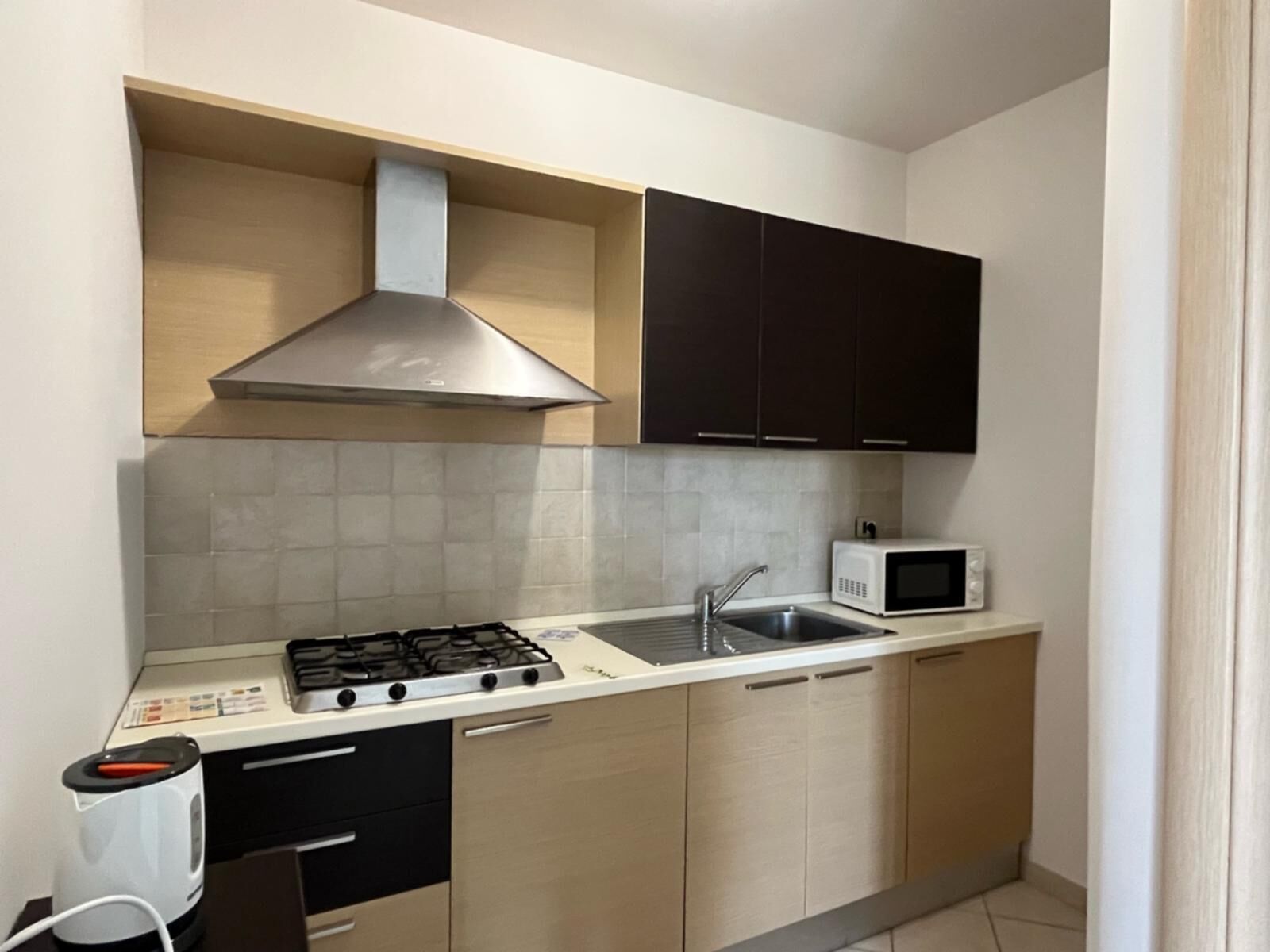 Fridge, microwave, coffee/tea maker, cookware/dishes/utensils