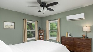 A bedroom with a bed, a ceiling fan, a dresser, and a window with curtains. - The Meadow! Peaceful Getaway! (Chattanooga Valley)