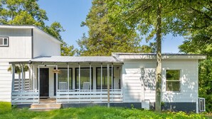 A two-story house with a porch and a small attached garage. - The Meadow! Peaceful Getaway! (Chattanooga Valley)