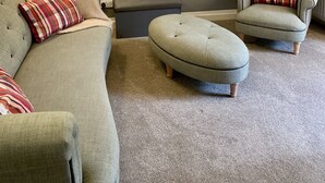 A living room with a grey sofa, two armchairs, a matching ottoman, a floor lamp, and a red and white striped pillow. - Stylish 2-Bedroom, Sleeps 5, Short walk to Durham City Centre, Wifi & Laundry (Durham)