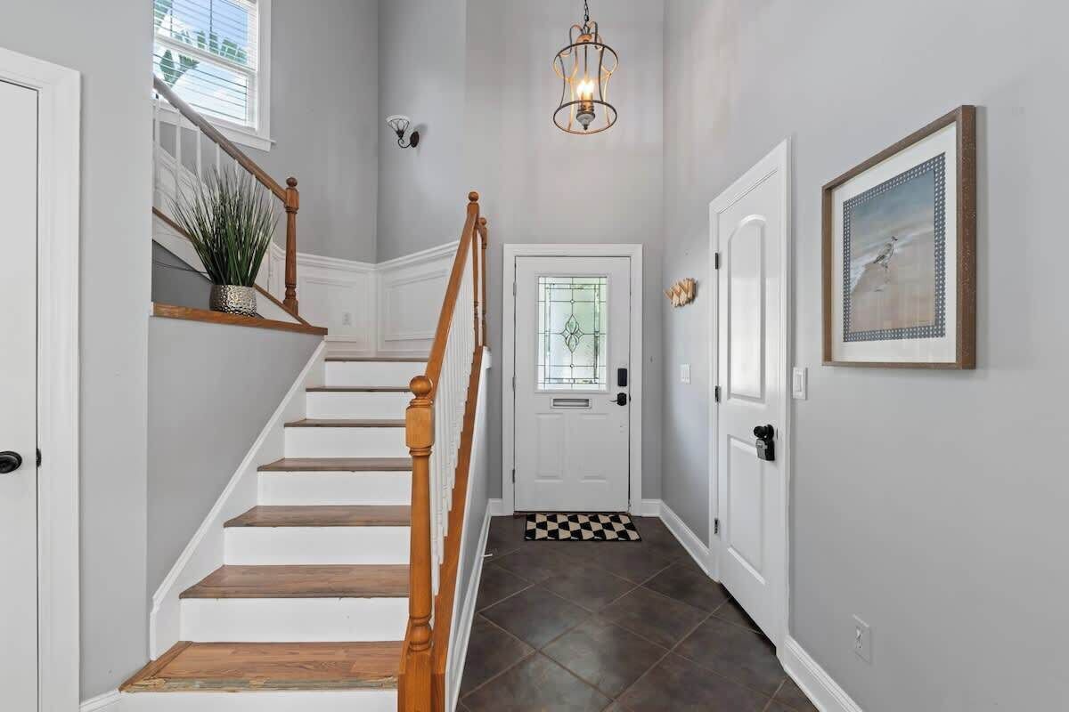 A staircase with wooden steps and a white door at the top.