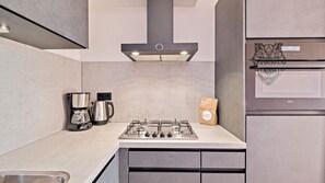 Fridge, stovetop, dishwasher, coffee/tea maker