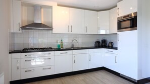Coffee/tea maker, cookware/dishes/utensils, dining tables