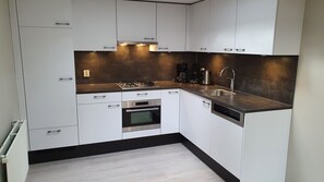 Fridge, stovetop, dishwasher, coffee/tea maker