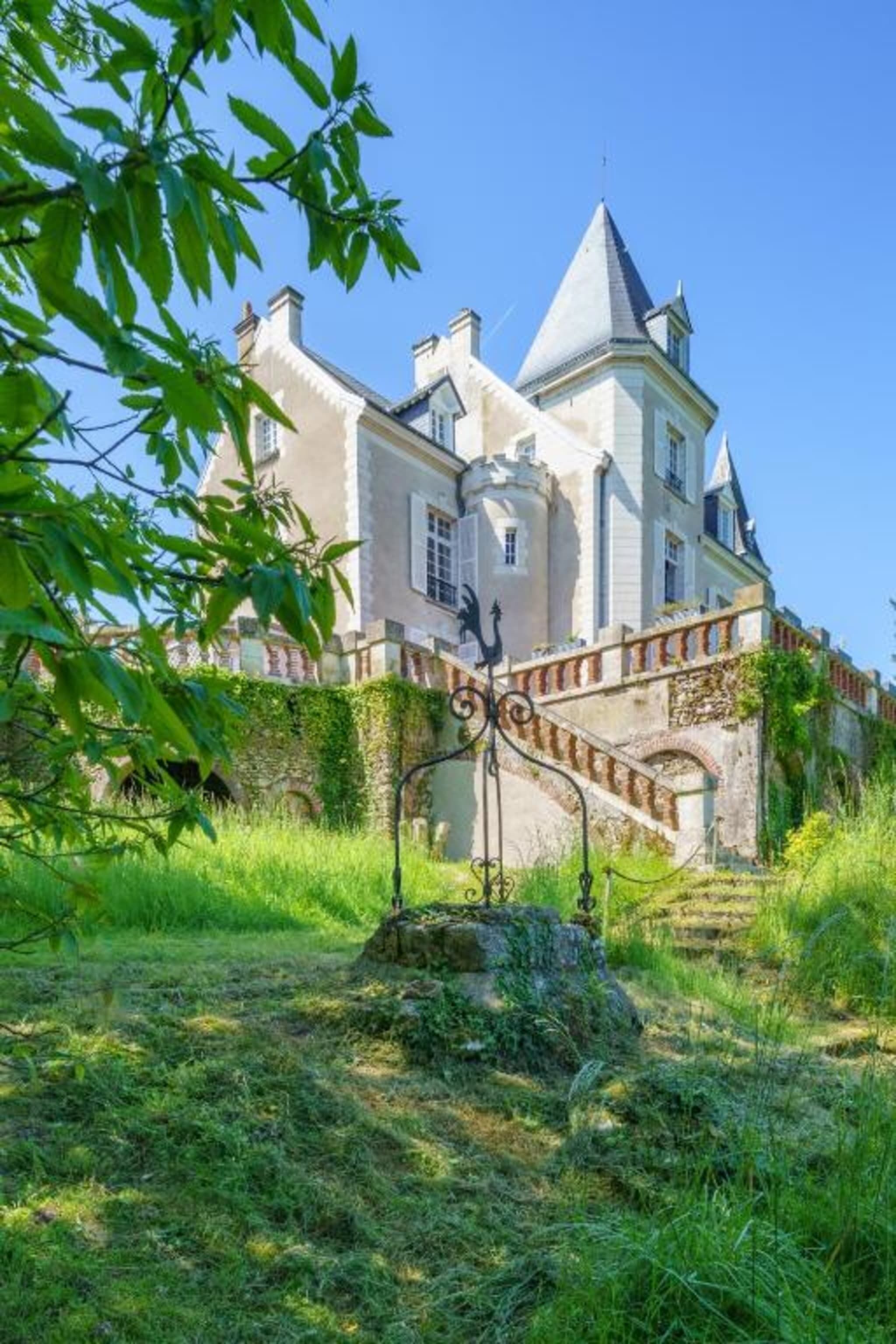 A large, historic building with a prominent staircase leading to the entrance.