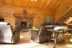 A wooden interior with a stone fireplace, leather recliners, and a wooden table with glasses. - A Slice of Salisbury-Pool, Hottub 10 Acre (Salisbury)
