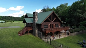 A log cabin with a balcony, a staircase, and a stone chimney. - A Slice of Salisbury-Pool, Hottub 10 Acre (Salisbury)