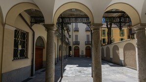 A corridor with arches, columns, and a tiled floor. - Casa Savoia by Wonderful Italy (Turin)