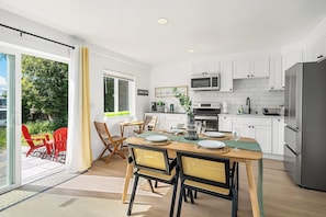 A modernistic blend of style and practicality, this kitchen opens into a vibrant outdoor space, perfect for that morning coffee in the sunlight.