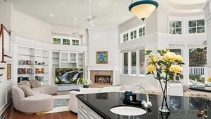 A spacious living room with a fireplace, a television, and a cozy seating area.