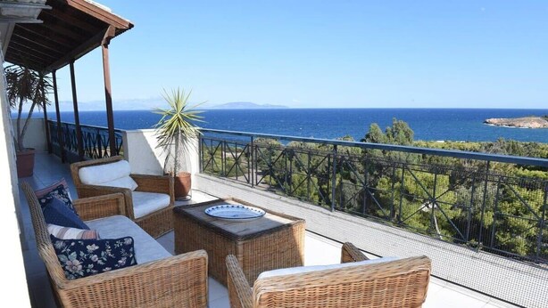 A balcony with wicker furniture, a potted plant, and a view of the sea. - Top floor 3bed 2bath with stunning 360 view (Athens)