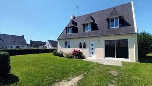 A two-story house with a dark roof, large windows, and a well-maintained lawn. - New : House, fully renovated, with garden, 200m from the beach - 3*** French property (Loctudy)