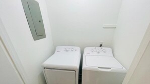 A small laundry room with two white front-loading washing machines. - Sunny Getaway * 1BR condo close to the beach (C) (Myrtle Beach)