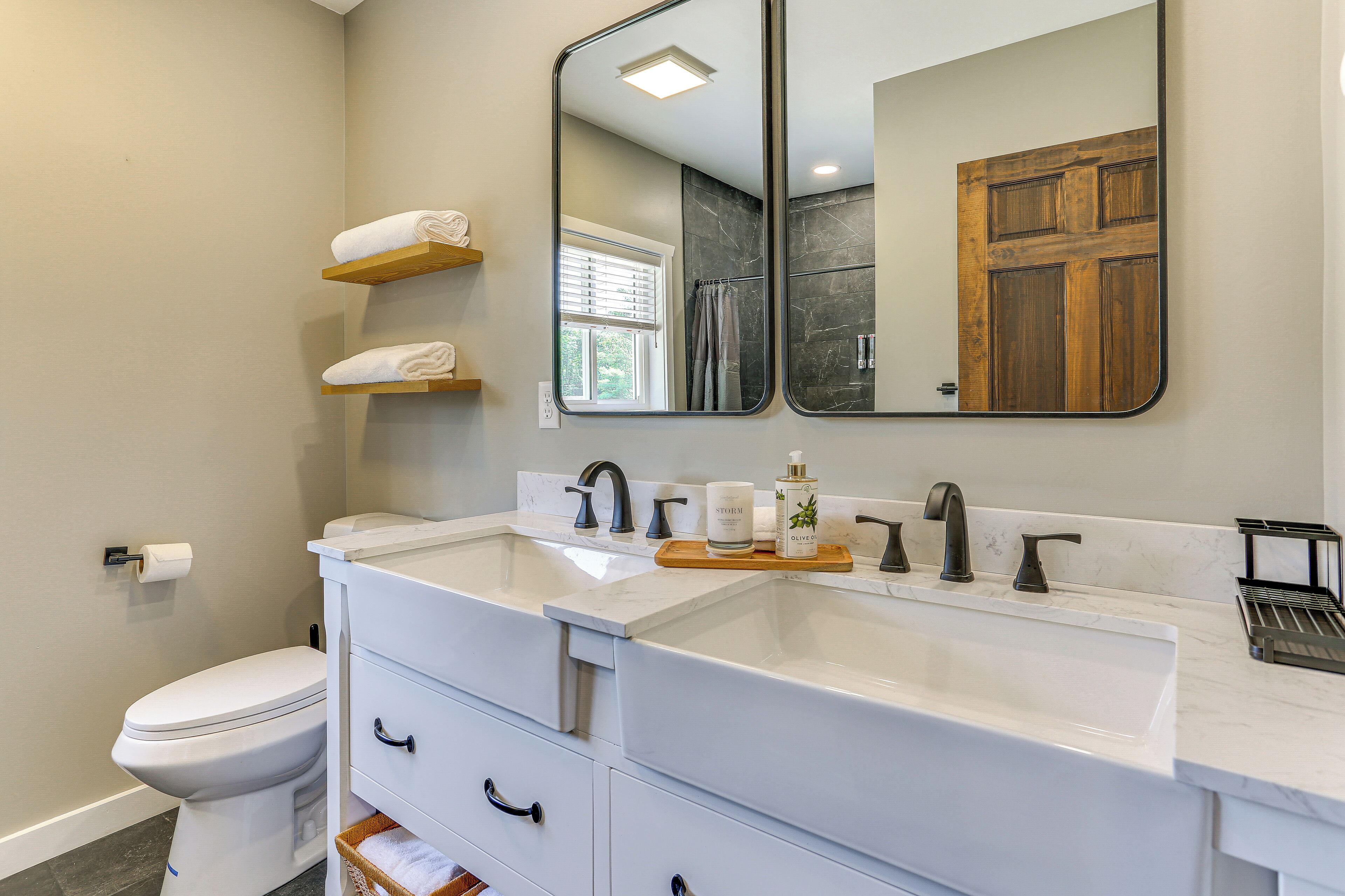 A modern bathroom with a white sink, double vanity, and a large mirror.
