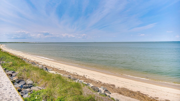 A beach with a clear sky and calm water.