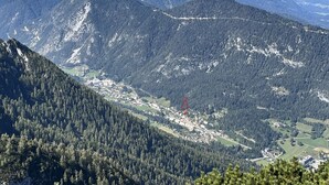 A mountainous landscape with a small town nestled in a valley. - Haus Im Hochtal - upstairs, 2 bedrooms apartment - small room with 2 single beds (Bad Bleiberg)