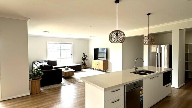 A modern kitchen with a central island, built-in appliances, and pendant lighting. - Nagambie Lakes: 5  BR, 2  BA House in Nagambie, Sleeps 10 (Nagambie)