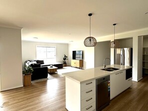 A modern kitchen with a central island, built-in appliances, and pendant lighting. - Nagambie Lakes: 5  BR, 2  BA House in Nagambie, Sleeps 10 (Nagambie)