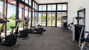 A gym with cardio machines, weight equipment, and large windows offering a view of the outdoors. - Nagambie Lakes: 5  BR, 2  BA House in Nagambie, Sleeps 10 (Nagambie)
