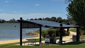 A gazebo with a roof and benches overlooking a lake. - Nagambie Lakes: 5  BR, 2  BA House in Nagambie, Sleeps 10 (Nagambie)