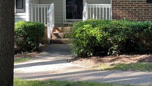 A residential house with a front porch, a brick section, and a mailbox with the number 2610. - Charming 2-bedroom townhome in wonderful Raleigh with WiFi, AC (Raleigh)
