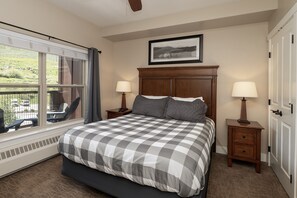 Relax in this inviting room with a large bed, nightstands, and a framed picture above.