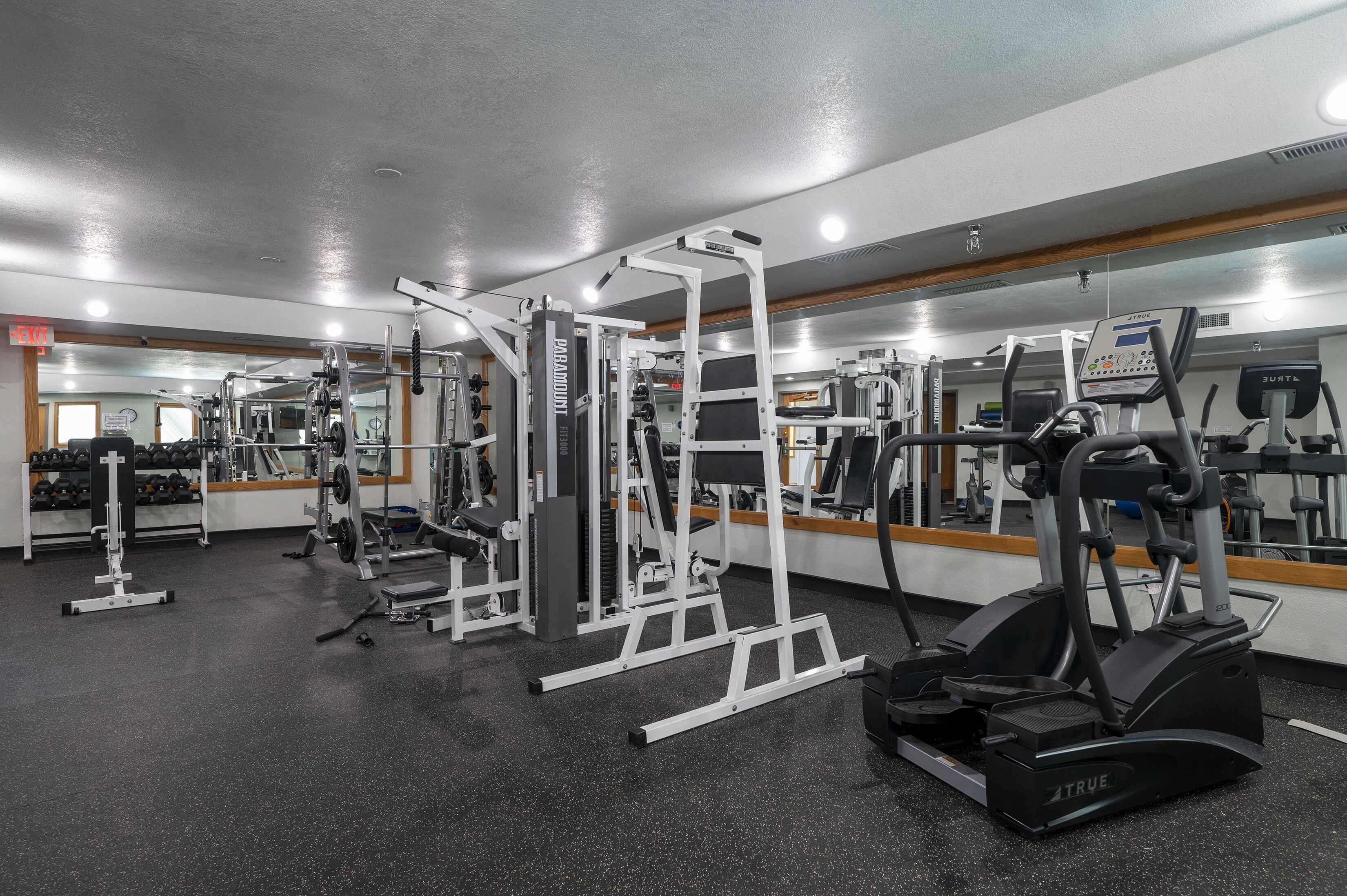 A gym with various exercise equipment, including treadmills and weight machines.